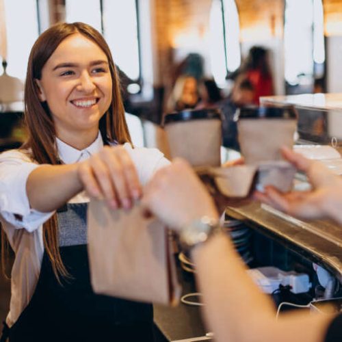 Woman taking coffee beverages at a coffee shop