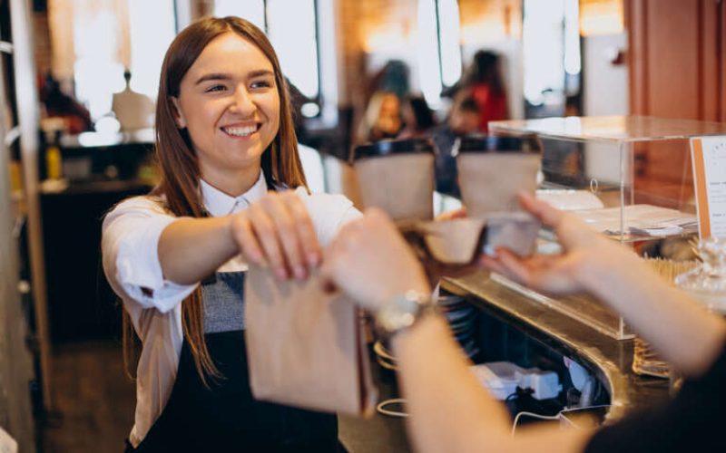 Woman taking coffee beverages at a coffee shop